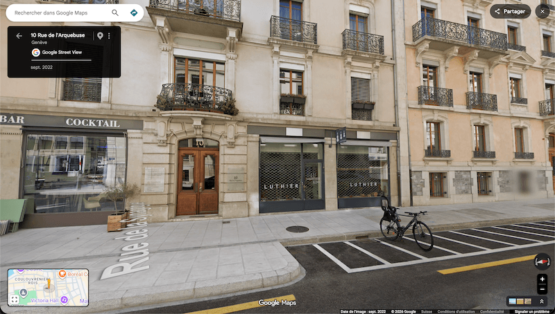 Google Street View of 10 Rue de l'Arquebuse in Geneva showing the Luthier shop window used for ambient night lighting