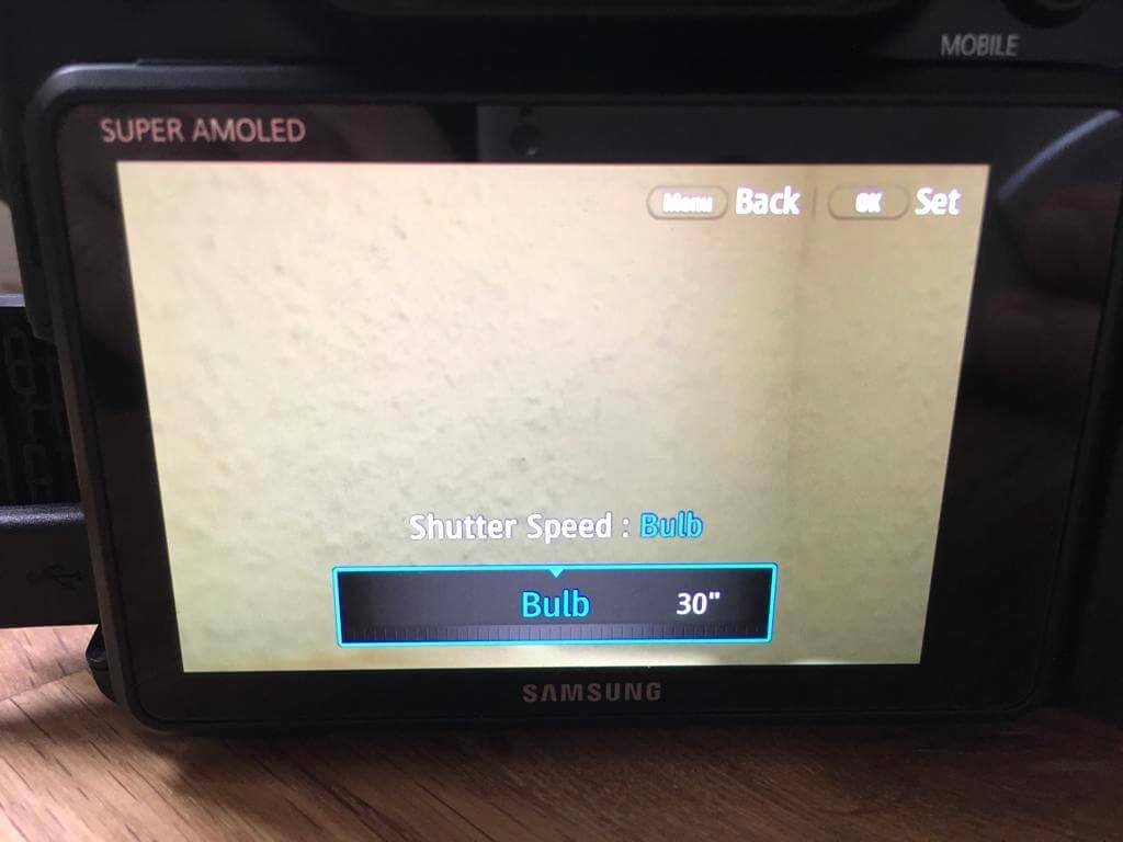 Samsung NX camera set to Bulb mode with remote control for long exposure photography