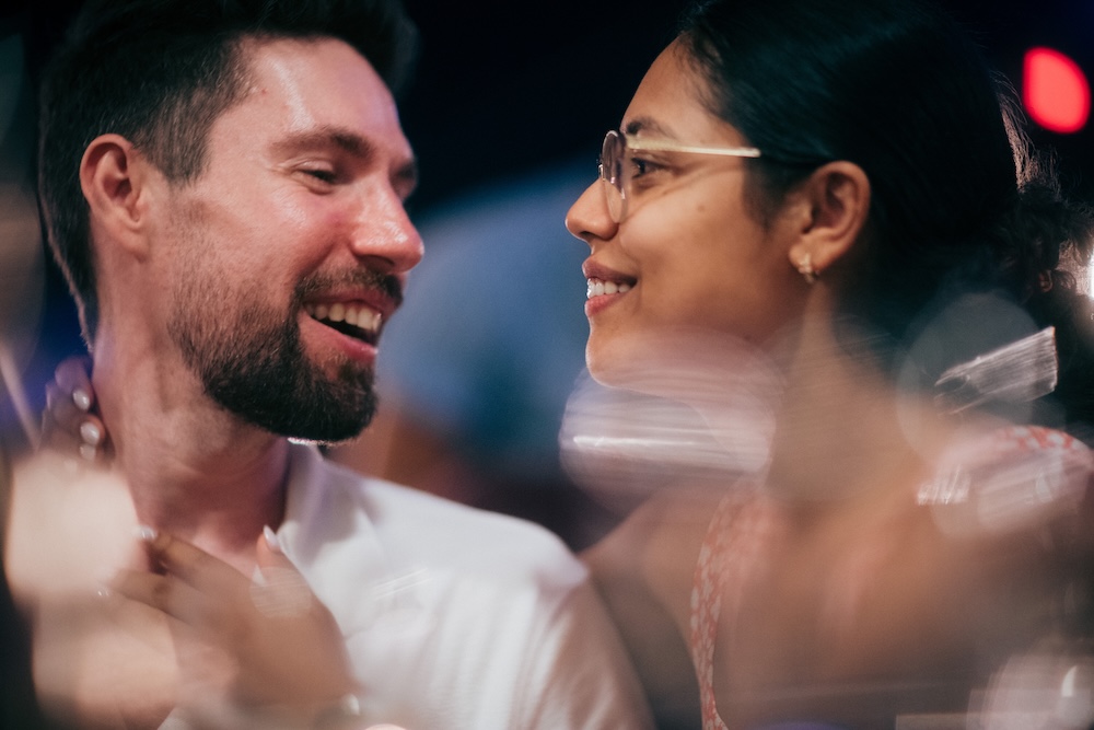 Cinematic candid couple portrait of a man and woman sharing a joyful moment at Bateau Genève in the Eaux-Vives area of Geneva.