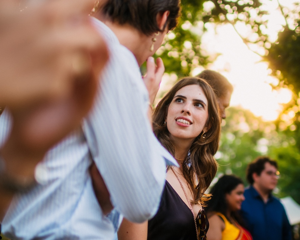 Cinematic candid photo of a guest taken at an outdoor wedding celebration in Romania.