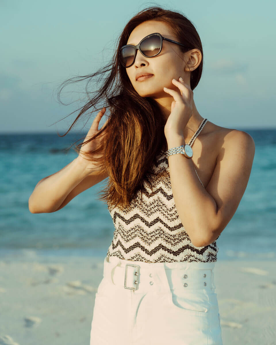 Fashion model photoshoot by the beach, outdoor portrait captured in natural light with a stylish editorial look