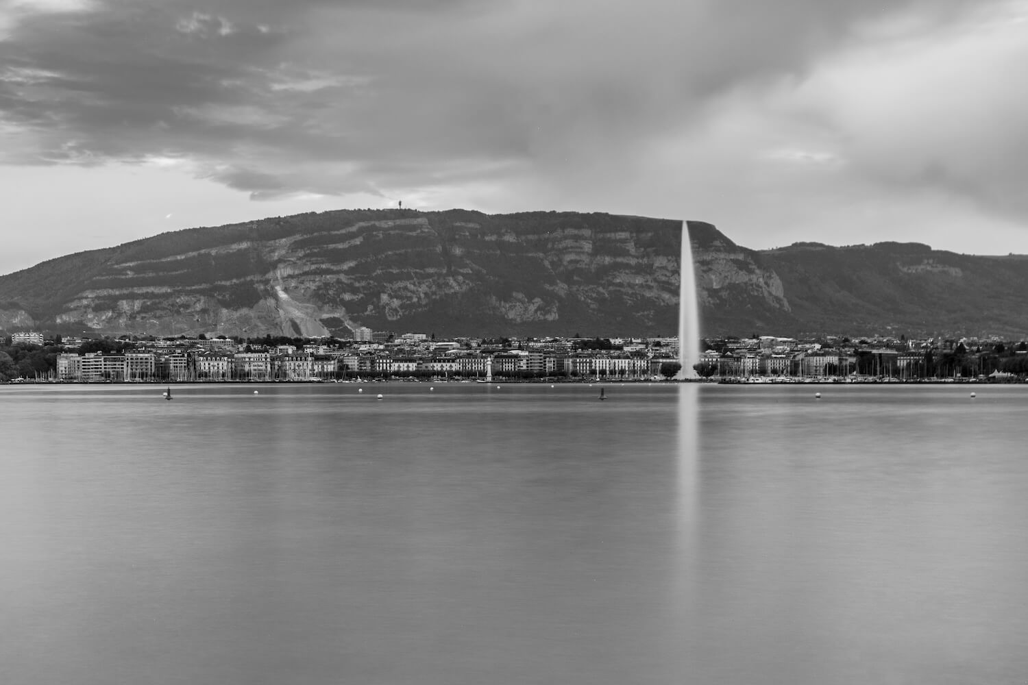 Fine art black and white photograph of the Jet d'Eau dominating Lake Geneva, captured with a long exposure