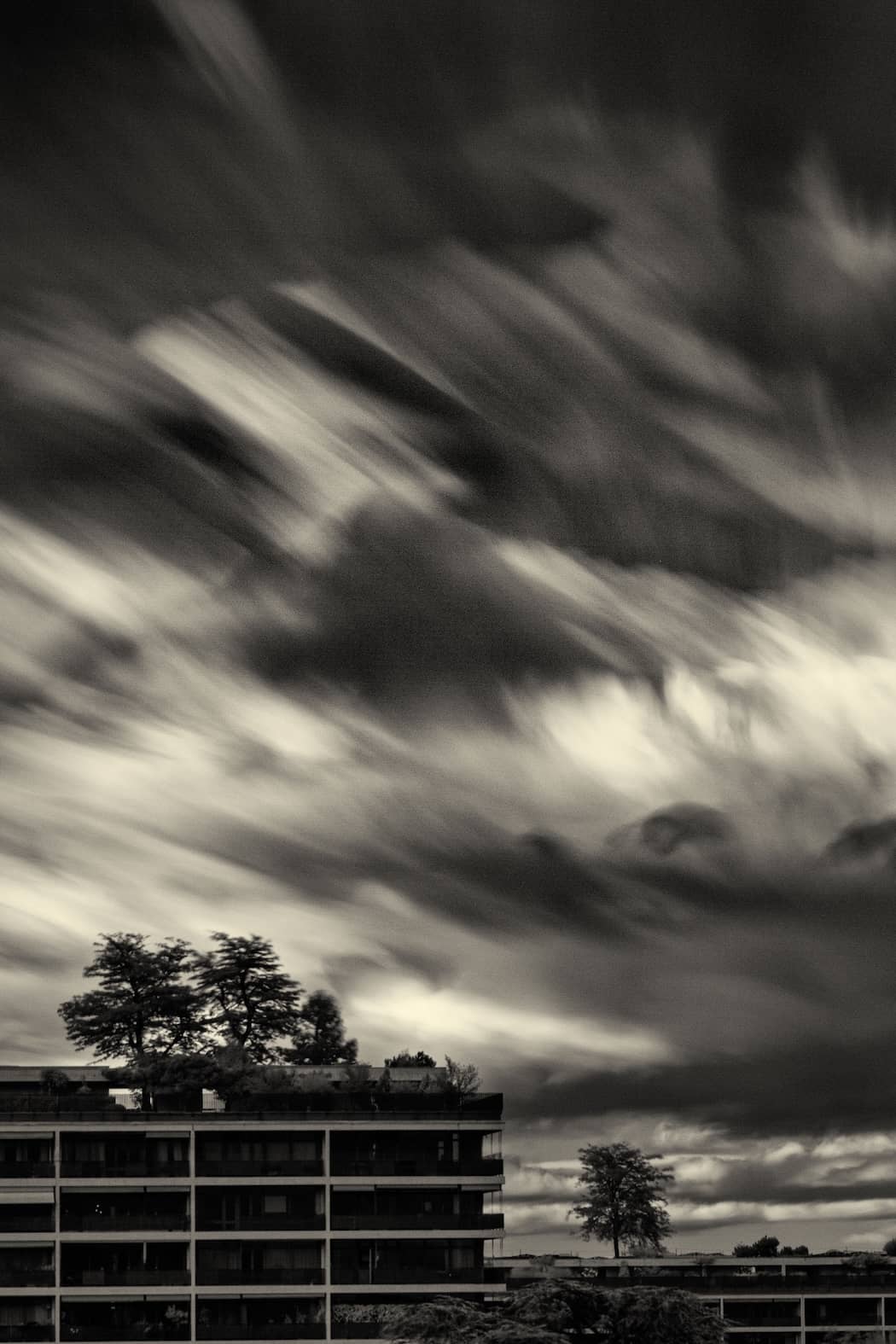 Black and white infrared photo of Geneva capturing storm clouds in motion—an unseen dance of light, energy, and atmosphere