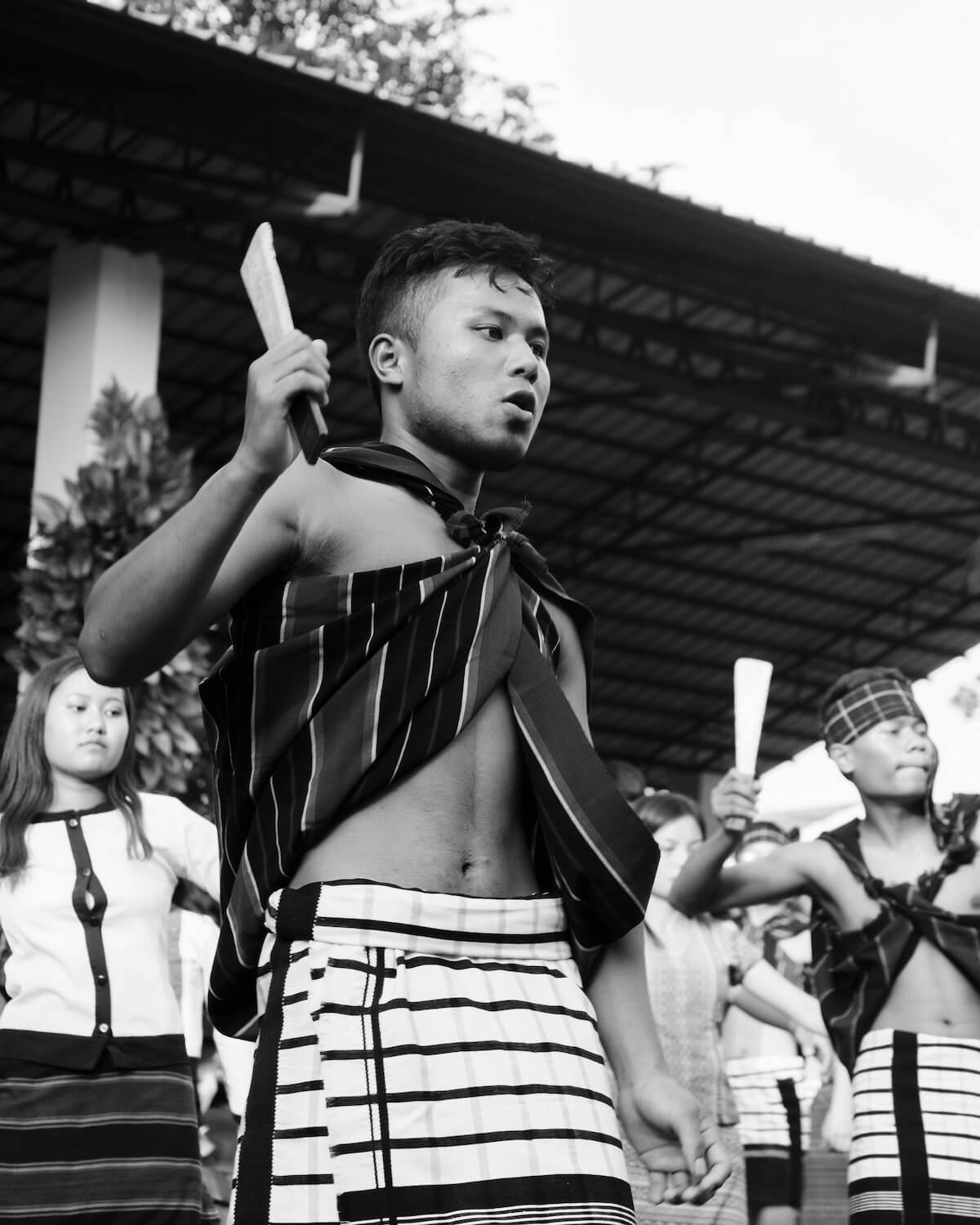 Men performing a traditional Mizo dance at the Anthurium Festival in Mizoram, India, 2019